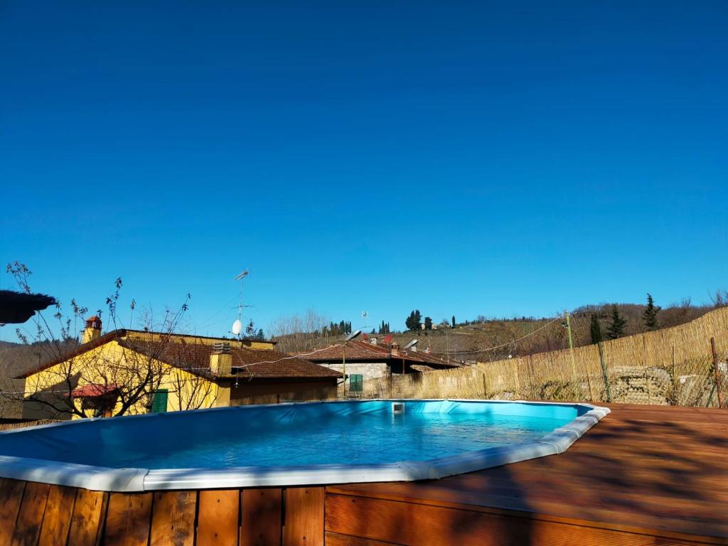 a blue swimming pool on a wooden fence at Casa Serena, Radda in Chianti, località Lucarelli. in Radda in Chianti