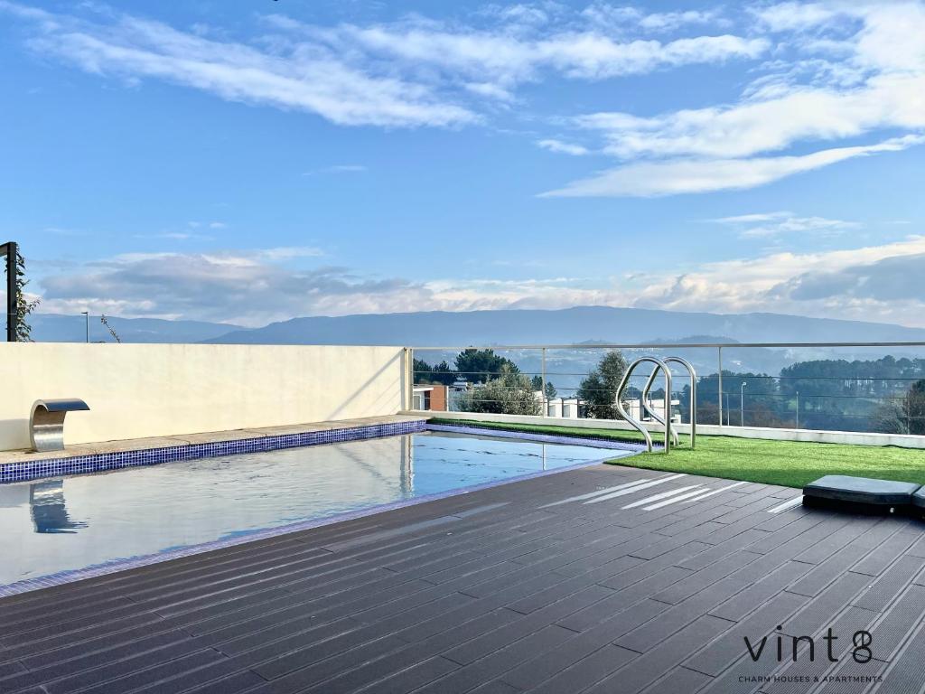 a swimming pool on the roof of a house at Casa do Golfe by VinteOito in Amarante