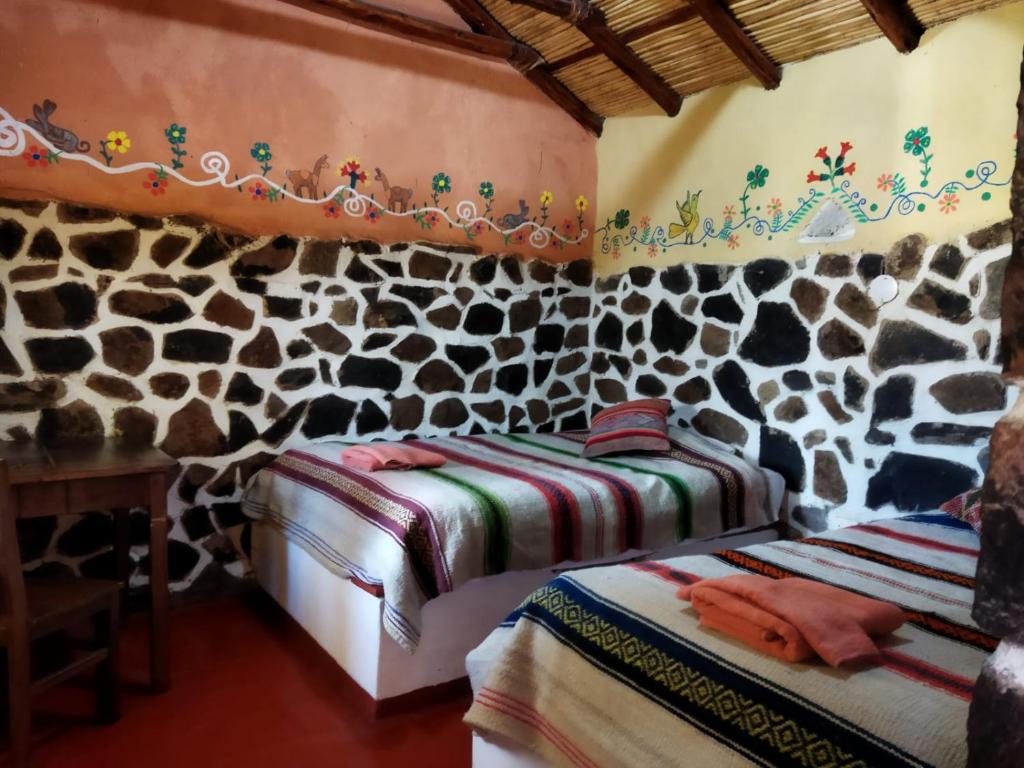 a room with a wall covered in fake giraffes at Lodge Mirador San Antonio- Colca in Coporaque