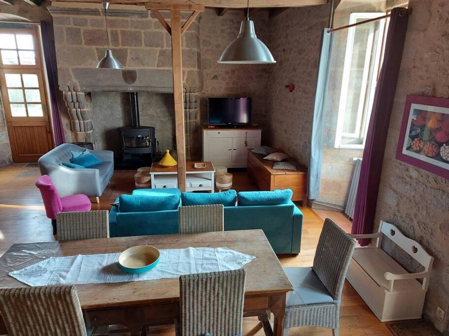 a living room with a blue couch and chairs at La Commanderie Grand Gite 10kms " Puy duFou" in Mauléon
