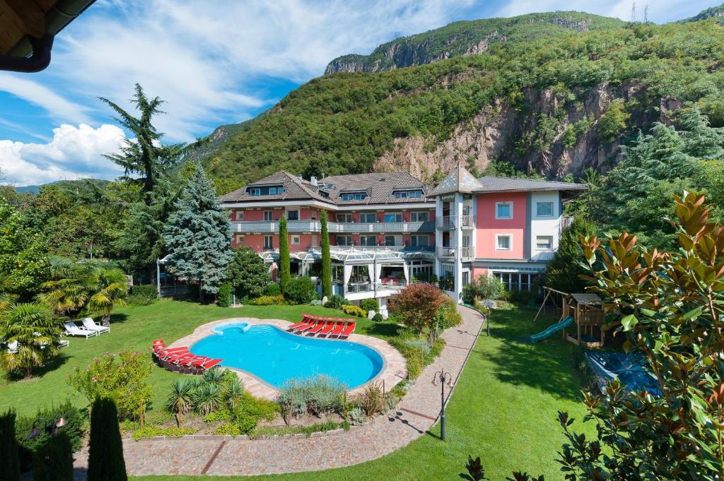 an exterior view of a resort with a swimming pool at Business Resort Parkhotel Werth in Bolzano