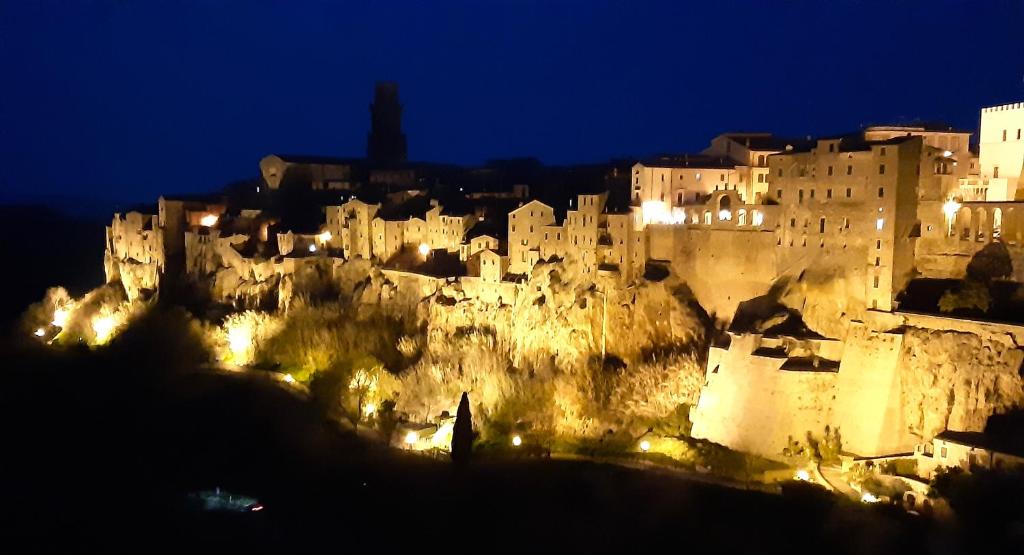 a city lit up at night with a castle at Casa del Sorriso in Elmo