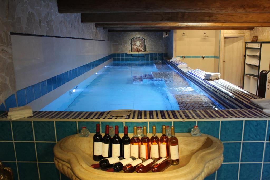 a swimming pool with a bunch of bottles of wine at I SEI FILARI in Capannori