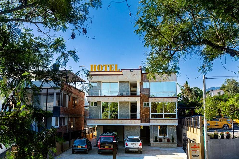 a hotel with cars parked in front of it at Hotel Explora in Chachagüí