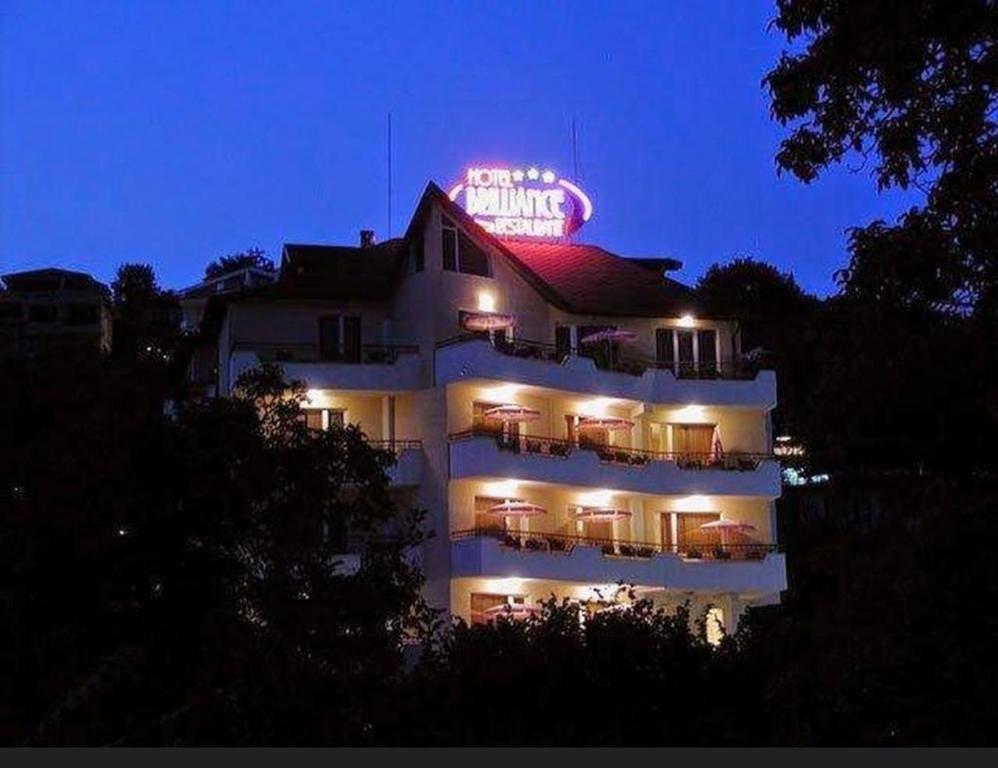 a building with a neon sign on top of it at Brilliance in Varna City