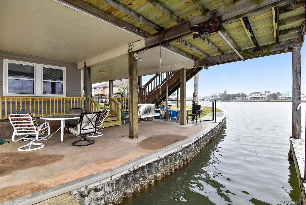 a house on the water with a table and chairs at Prager Bay View in Galveston