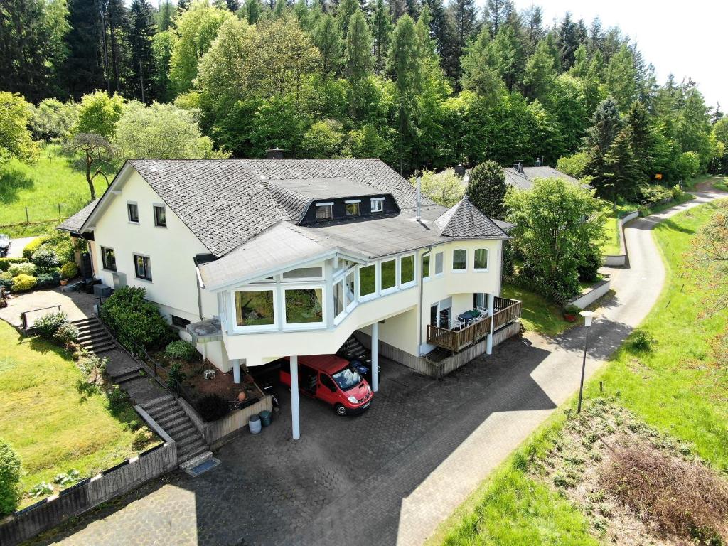 an aerial view of a house with a car parked in the driveway at Haus Im Wald 