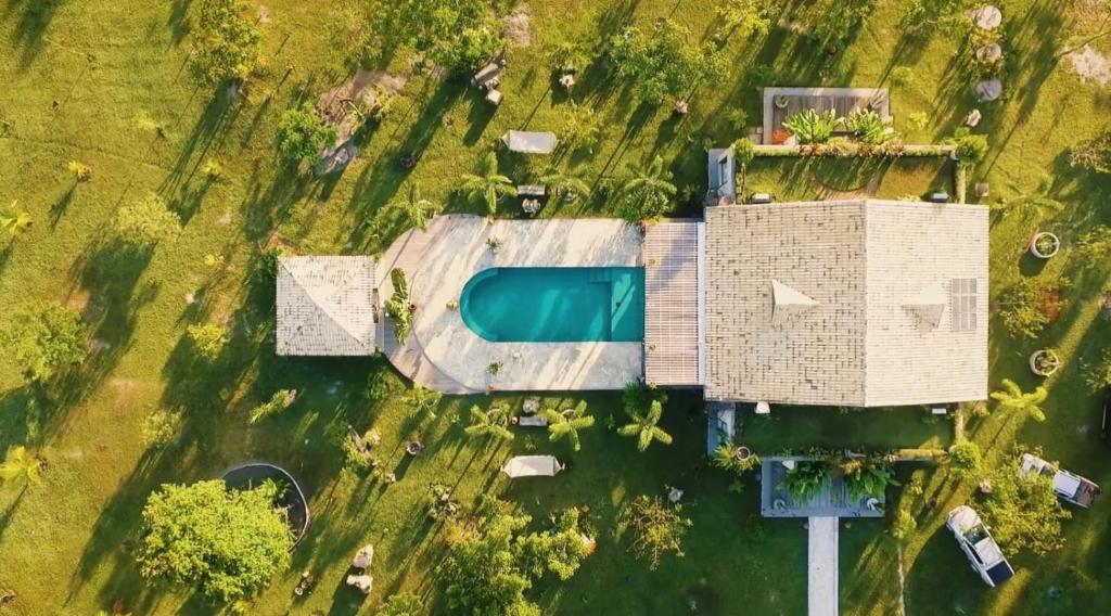 an aerial view of a building with a swimming pool at Kaza Mazamore - Entire luxurious Vila in Itaunas. in Conceição da Barra
