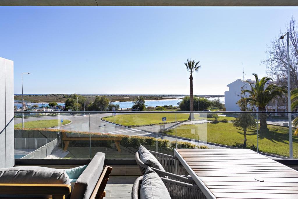 a balcony with a table and chairs and a view of the ocean at My Ocean View in Cabanas de Tavira