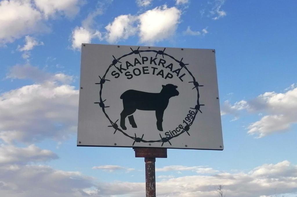 a sign with a goat in the middle at Skaap Kraal Guest Farm in Kakamas