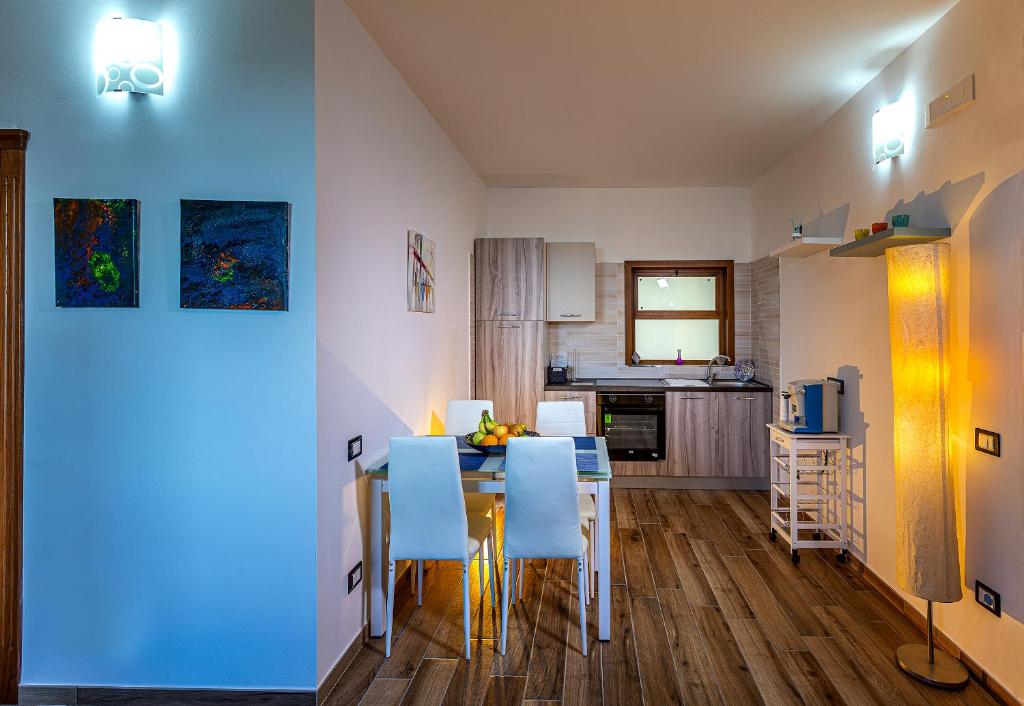 a kitchen and dining room with a table and chairs at La Dimora del Duca Classic in Giungano