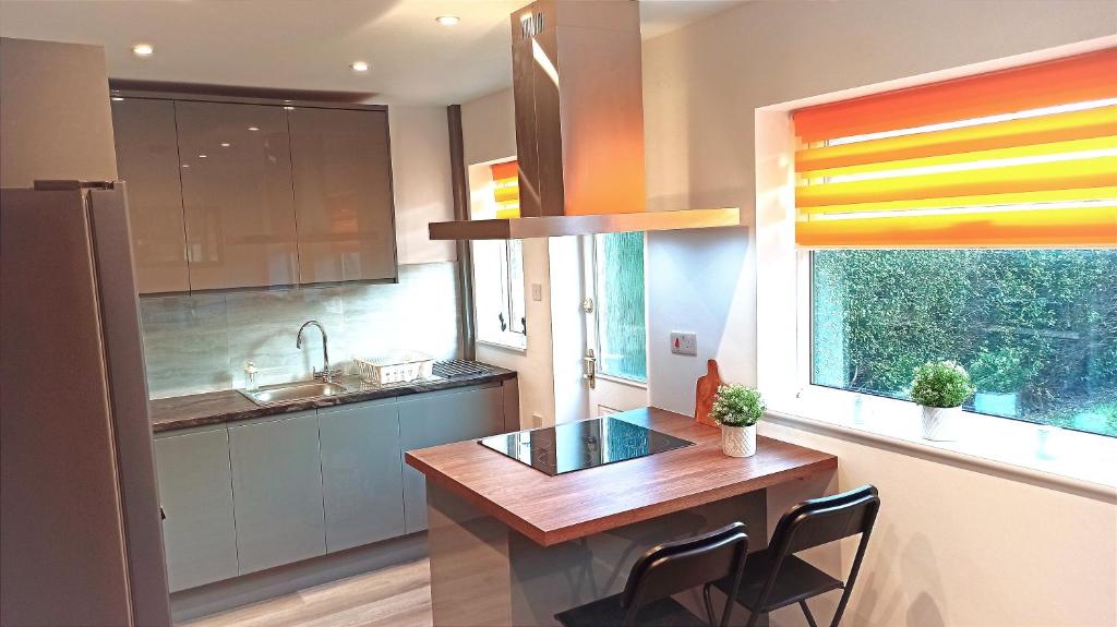 a kitchen with a wooden table and a window at Stunning 3 bed House sleeps 5-6, WiFi, OFF Street Parking in Nottingham close to M1 in Nottingham