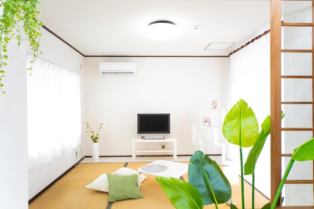 a living room with a tv and plants at Higashiomi - House - Vacation STAY 14173 in Higashiomi