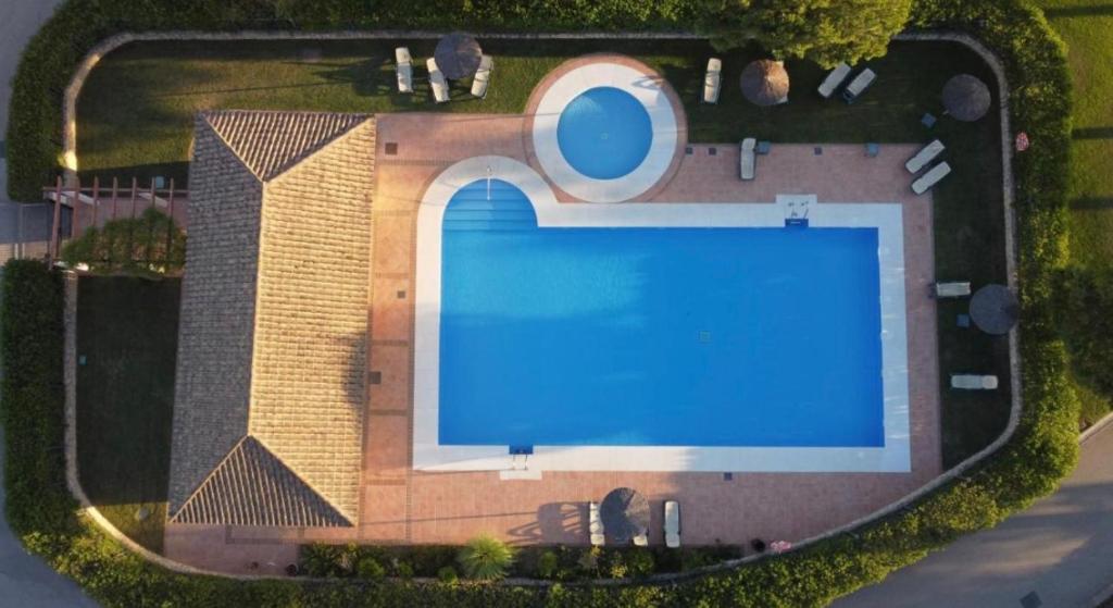 an overhead view of a swimming pool in front of a house at Arcos Gardens in Arcos de la Frontera