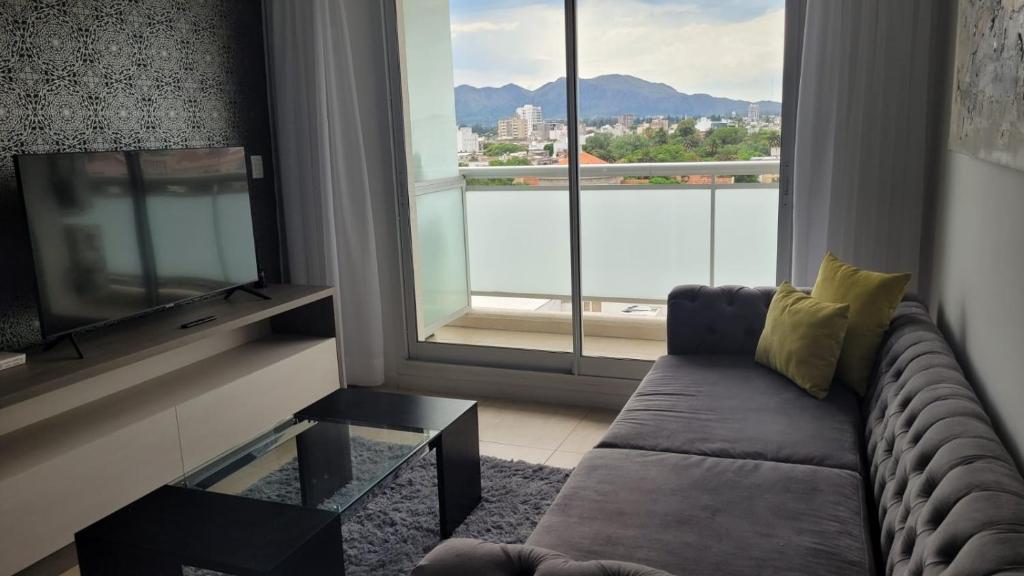 a living room with a couch and a large window at Dessau VI in San Luis