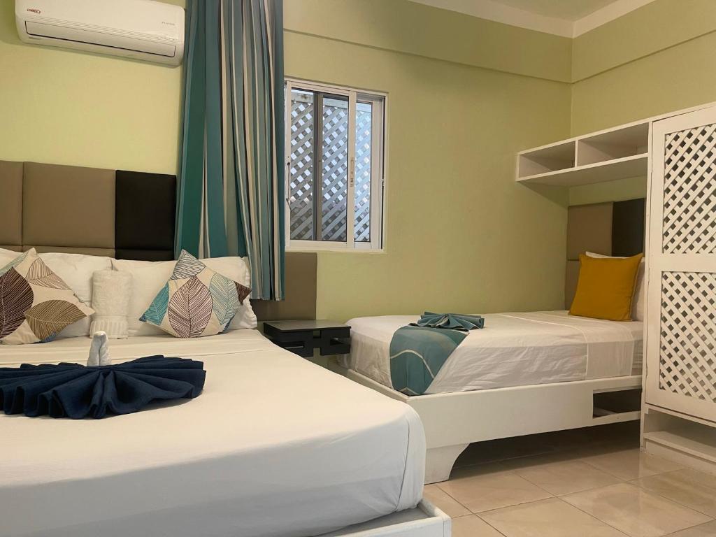 Postel nebo postele na pokoji v ubytování Villa Iguana