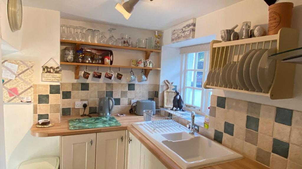 a kitchen with a sink and a counter top at Cosy Nook in North Molton