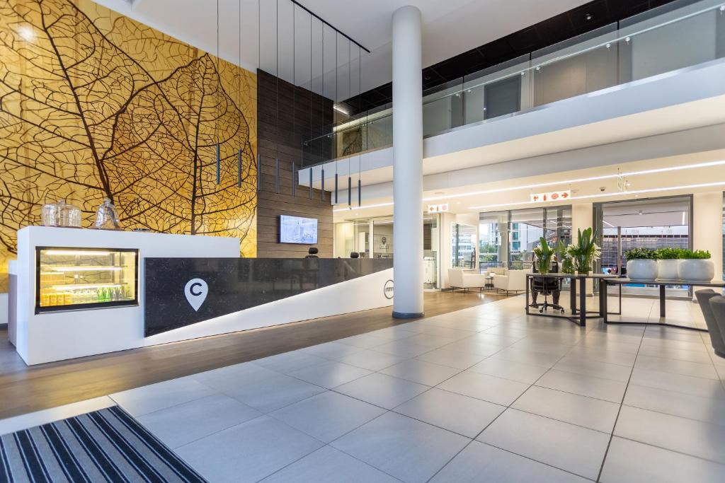 a lobby of an office building with a reception desk at Menlyn Maine - The Trilogy Apartment 1111 in Pretoria