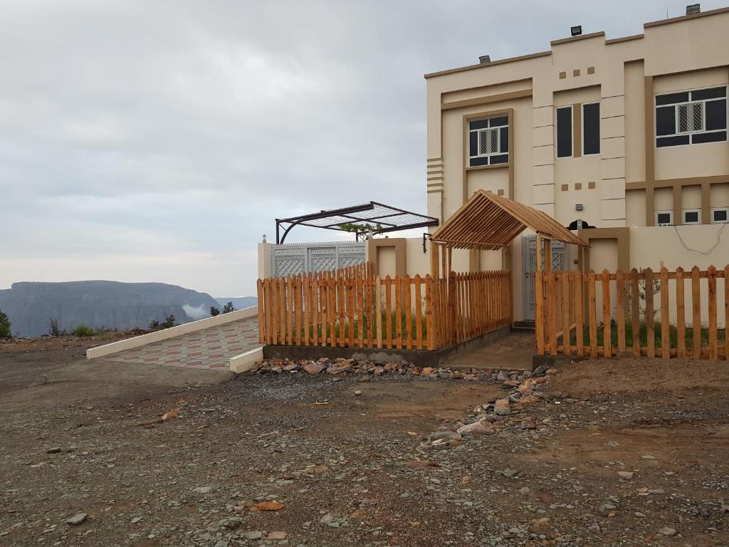 a house with a wooden fence in front of it at .Alshorfa _ House. in Qurayyah