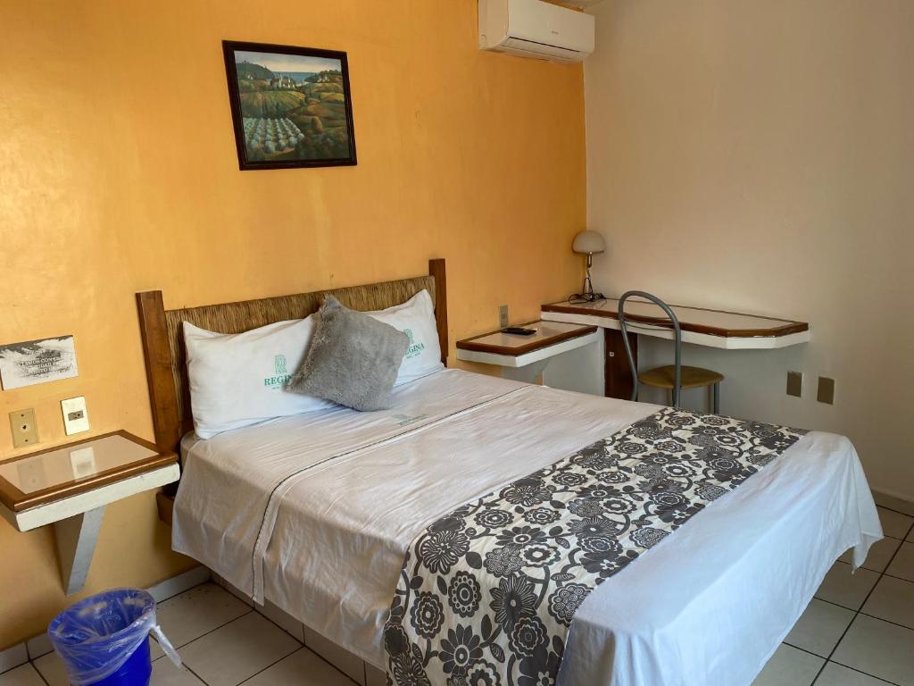 Postel nebo postele na pokoji v ubytování Hotel Suites Regina