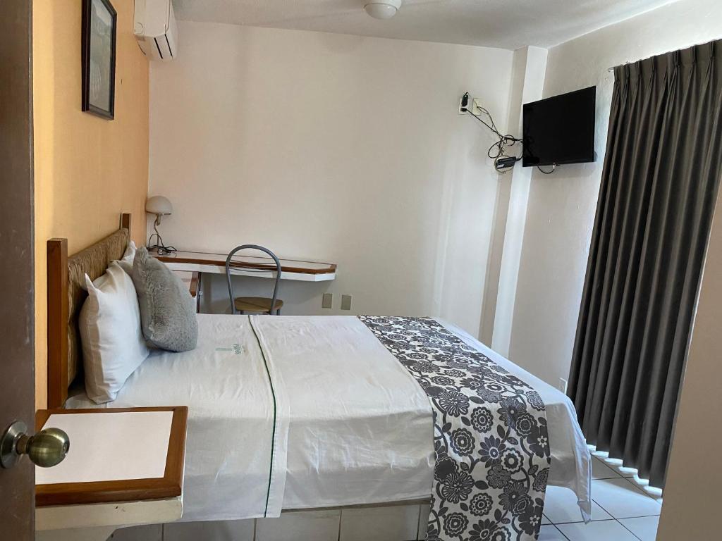 Postel nebo postele na pokoji v ubytování Hotel Suites Regina