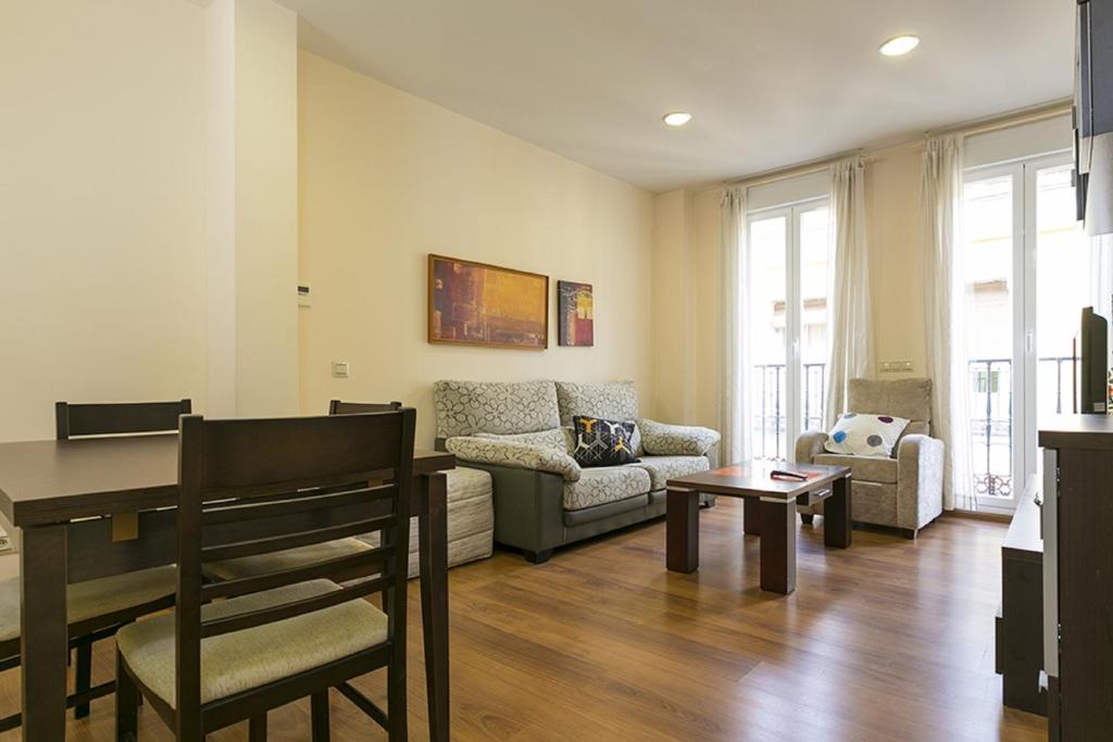 a living room with a couch and a table at Apartments Center Madrid in Madrid