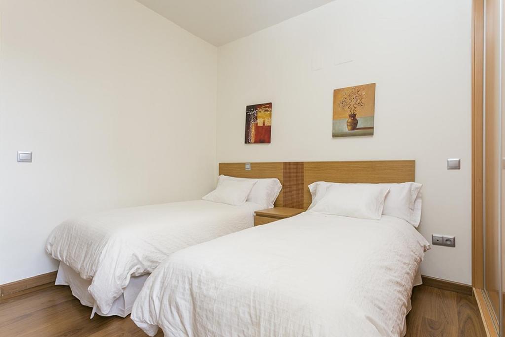 Postel nebo postele na pokoji v ubytování Apartments Center Madrid