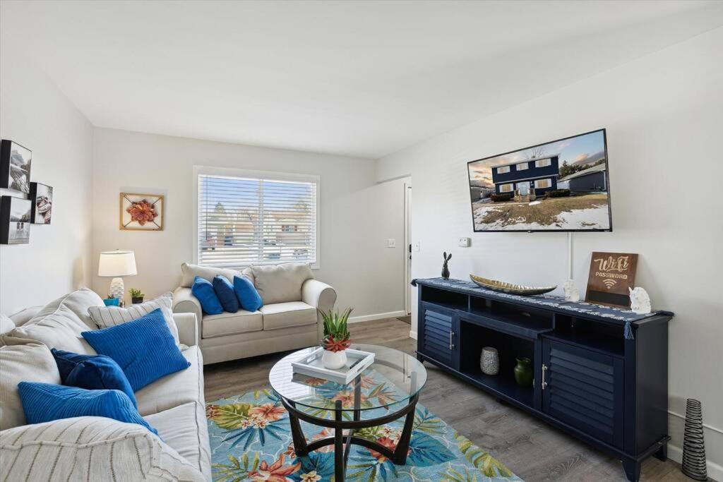 a living room with a couch and a fireplace at Pet-Friendly Large-Group Oasis in Bay City