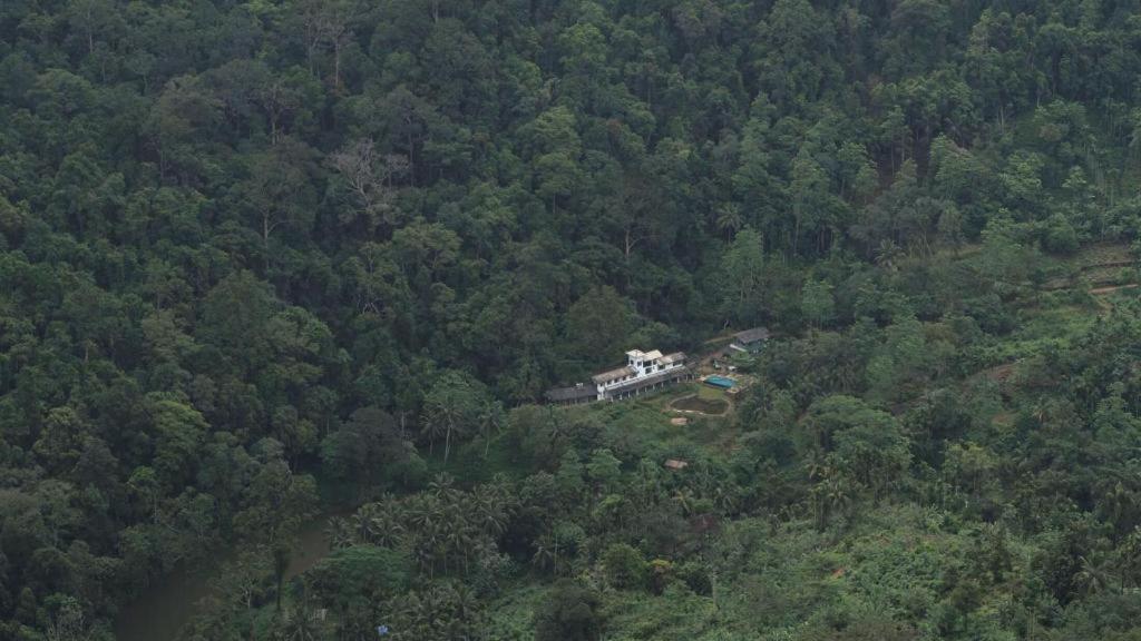 an aerial view of a house in the middle of a forest at Explore Sinharaja Rain Forest Tour Camp in Dombagoda