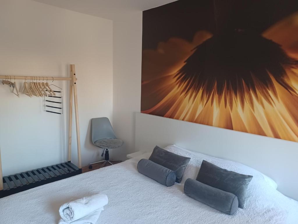 a bedroom with a bed with a large picture on the wall at Apartment M&amp;A in Osijek