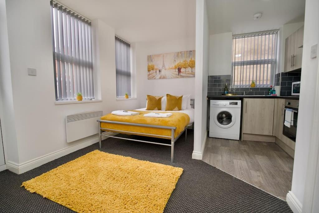 a living room with a bed and a kitchen at Swan Studio One - Coventry in Coventry