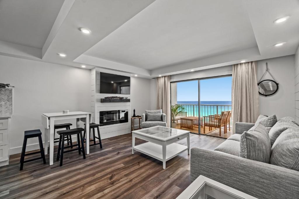 a living room with a couch and a table at The Summit 803 - Luxury Beach Resort Condo - Beachfront - Incredible Views - BEACH CHAIRS AND SUNSHADE Provided In Condo in Panama City Beach