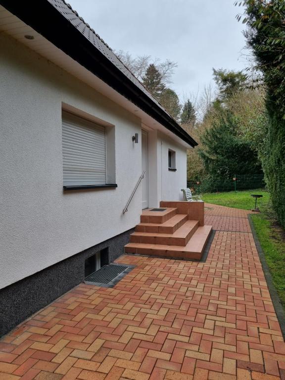 a brick patio with stairs next to a house at Ferienwohnung an der Ostsee in Lütjenburg