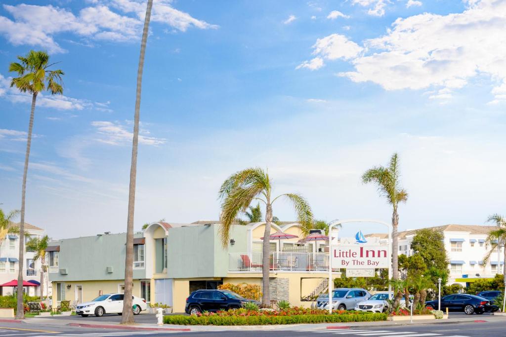 un aparcamiento con palmeras frente a un hotel en Little Inn By The Bay Newport Beach Hotel, en Newport Beach