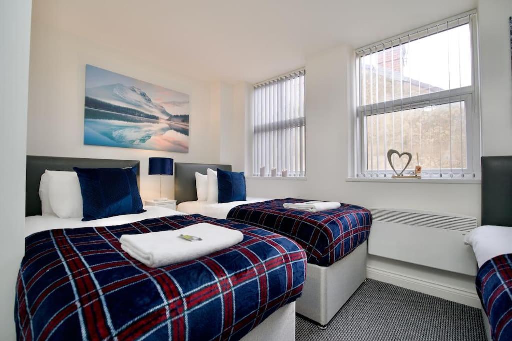 a hotel room with two beds and a window at Swan Studio Six - Coventry in Coventry