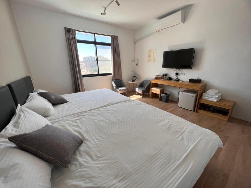 Postel nebo postele na pokoji v ubytování 黃金海岸 Gold Coast 近奇美博物館