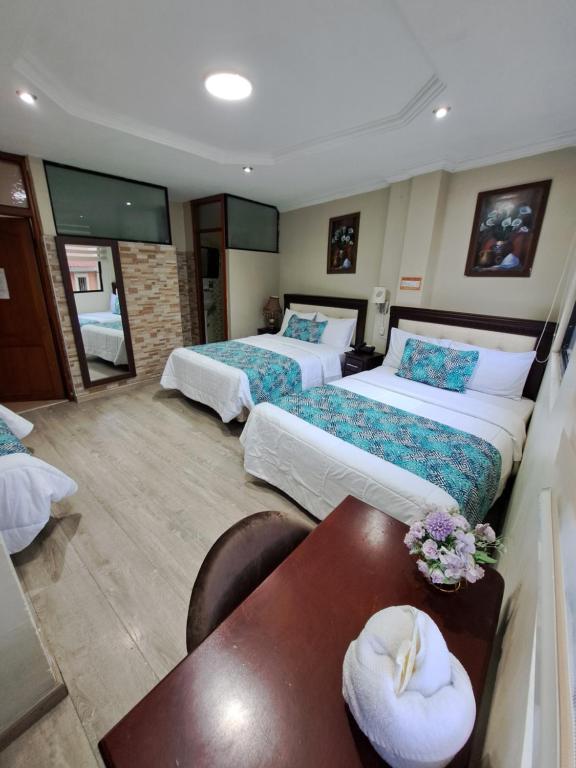 Postel nebo postele na pokoji v ubytování Hotel Virgen del Cisne