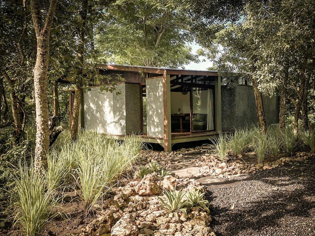 a small house in the middle of a forest at Grün Resort Uluwatu in Uluwatu