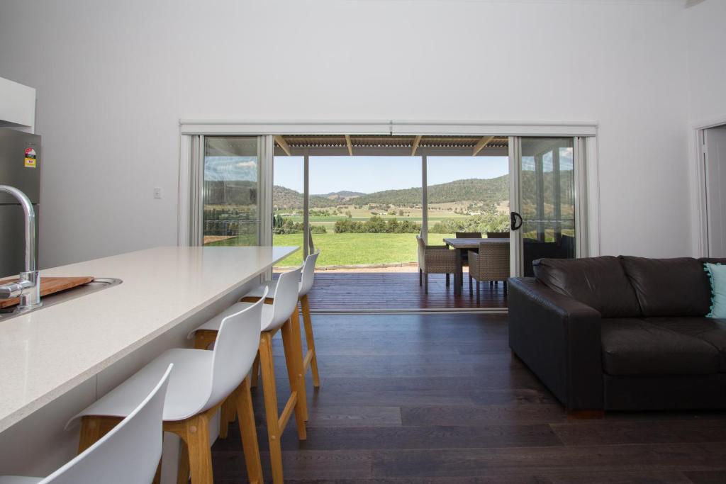 a kitchen and living room with a table and chairs at Stay in Mudgee in Mudgee