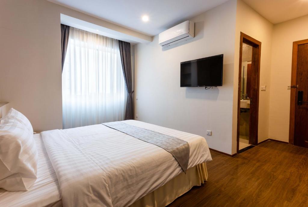 Postel nebo postele na pokoji v ubytování Joli Hotel