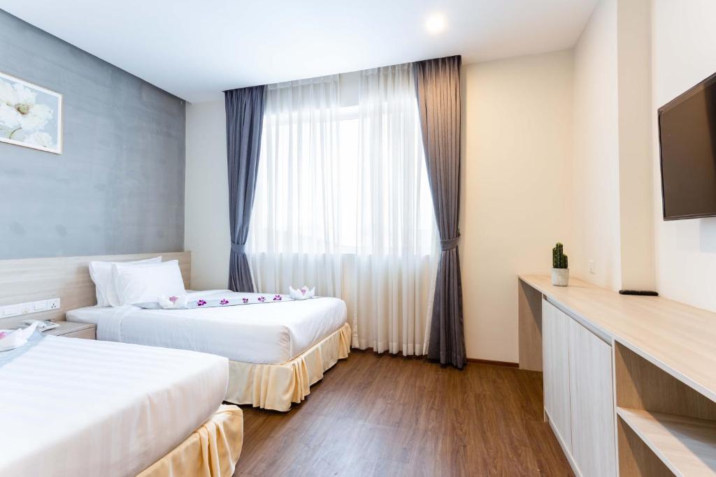 Postel nebo postele na pokoji v ubytování Joli Hotel