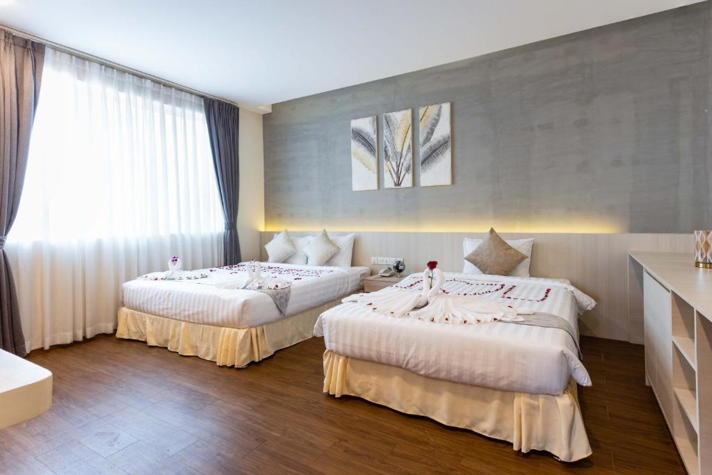 Postel nebo postele na pokoji v ubytování Joli Hotel