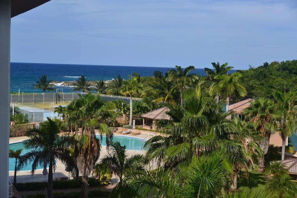 an aerial view of a resort with a swimming pool and the ocean at 3Bedroom Vacation Condo Resort 3 in Ocho Rios