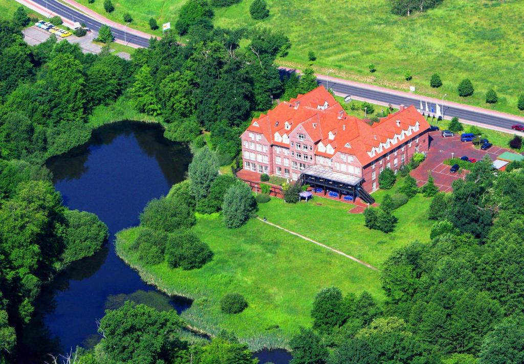 an aerial view of a large house with a lake at Park Hotel Fasanerie Neustrelitz in Neustrelitz