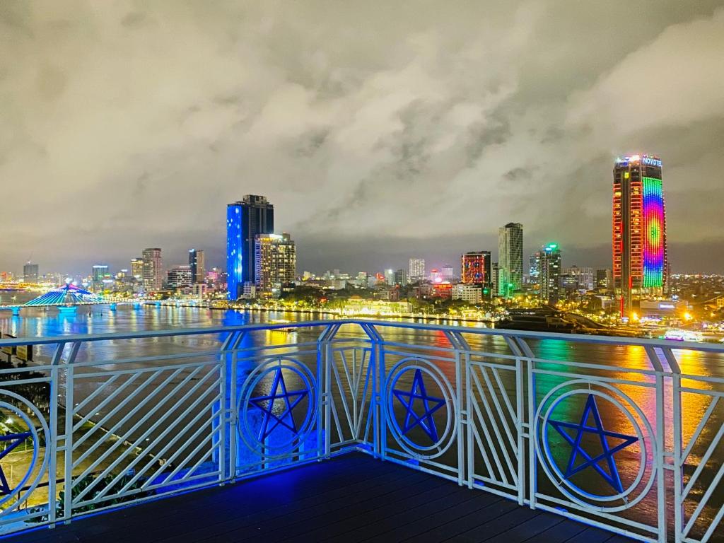 a view of a city skyline at night at Star City Riverside Hotel By Haviland in Danang