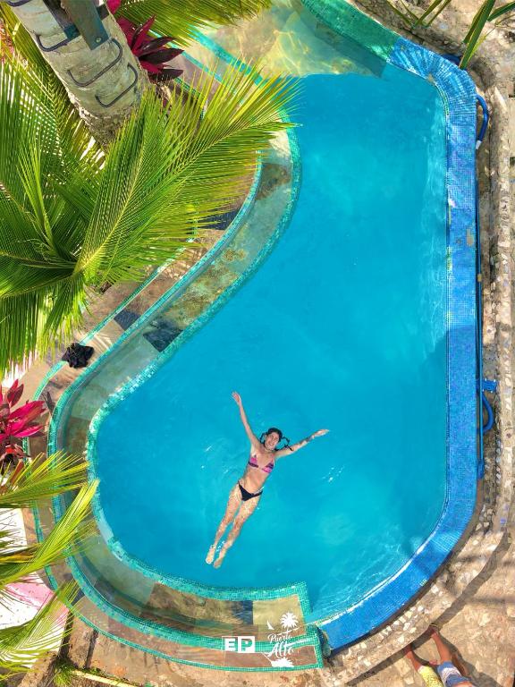 a woman in a bikini swimming in a swimming pool at Mirador Puerto Alto in Buritaca