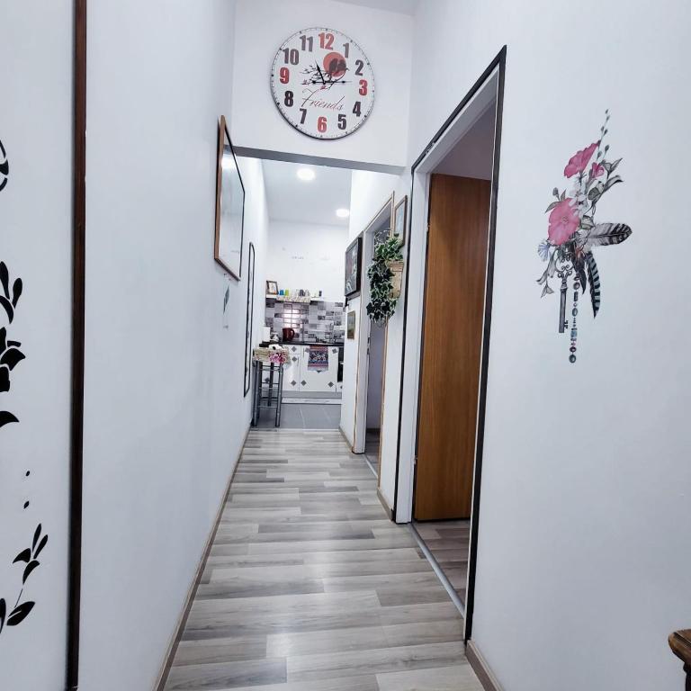 a hallway with a clock on the wall at EMAN SWEET HOME - cozy privet unique apartment in haifa downtown in Haifa