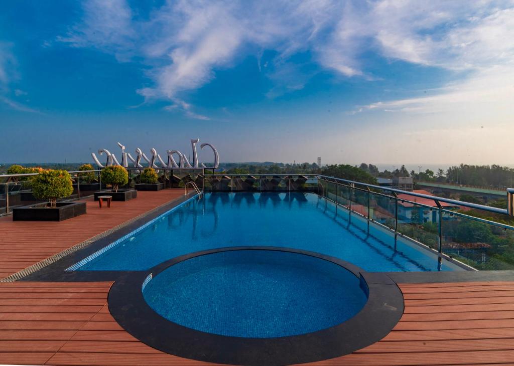 a swimming pool on the roof of a building at Classic Regency in Alleppey
