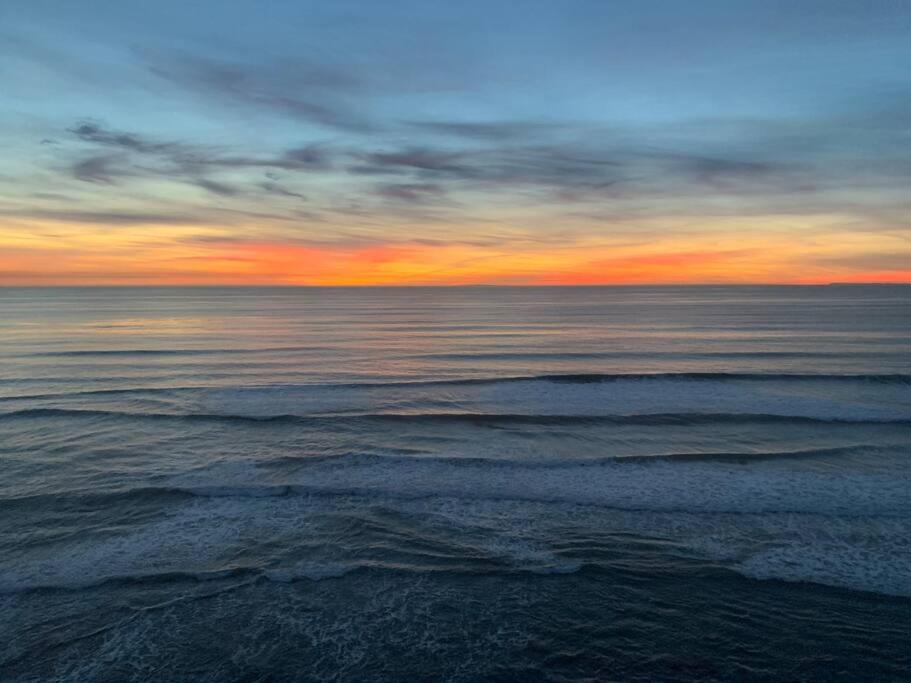 a view of the ocean at sunset at Steps To The BEST Beach . Surf . Spa . Main Street in Encinitas