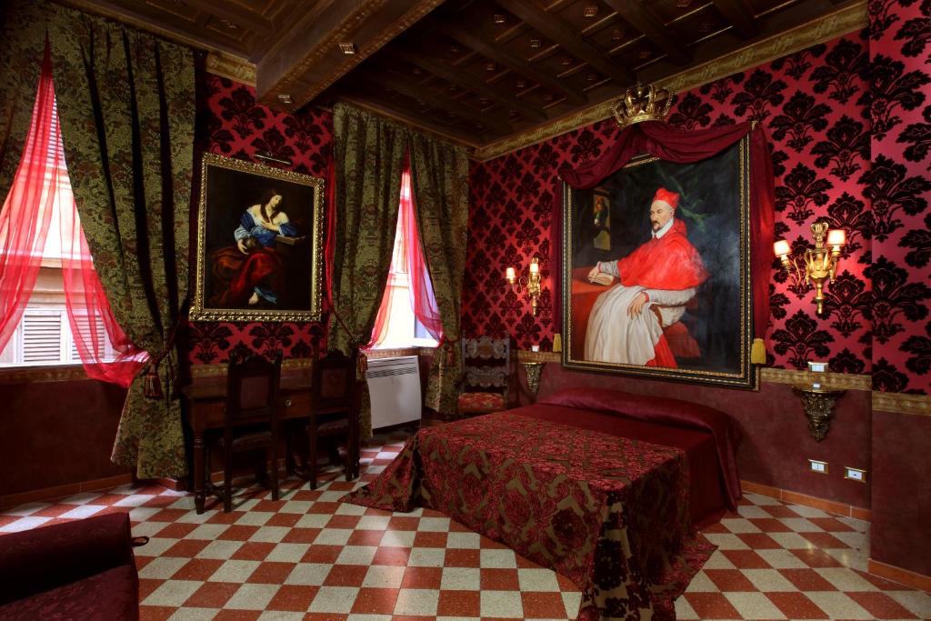 a bedroom with a bed and a painting of a woman at Antica Dimora De Michaelis in Rome